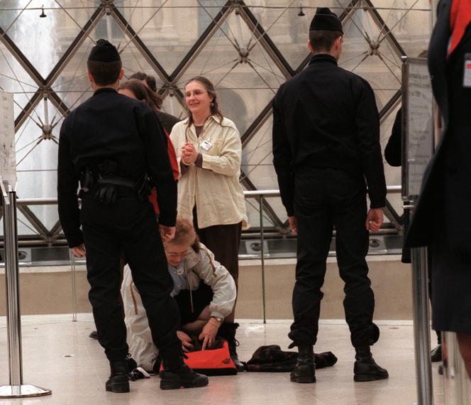 Des policiers fouillent des visiteurs à la sortie du musée du Louvre, après le vol du tableau « Le Chemin de Sèvres », de Camille Corot, le 3 mai 1998. JACK GUEZ/AFP
